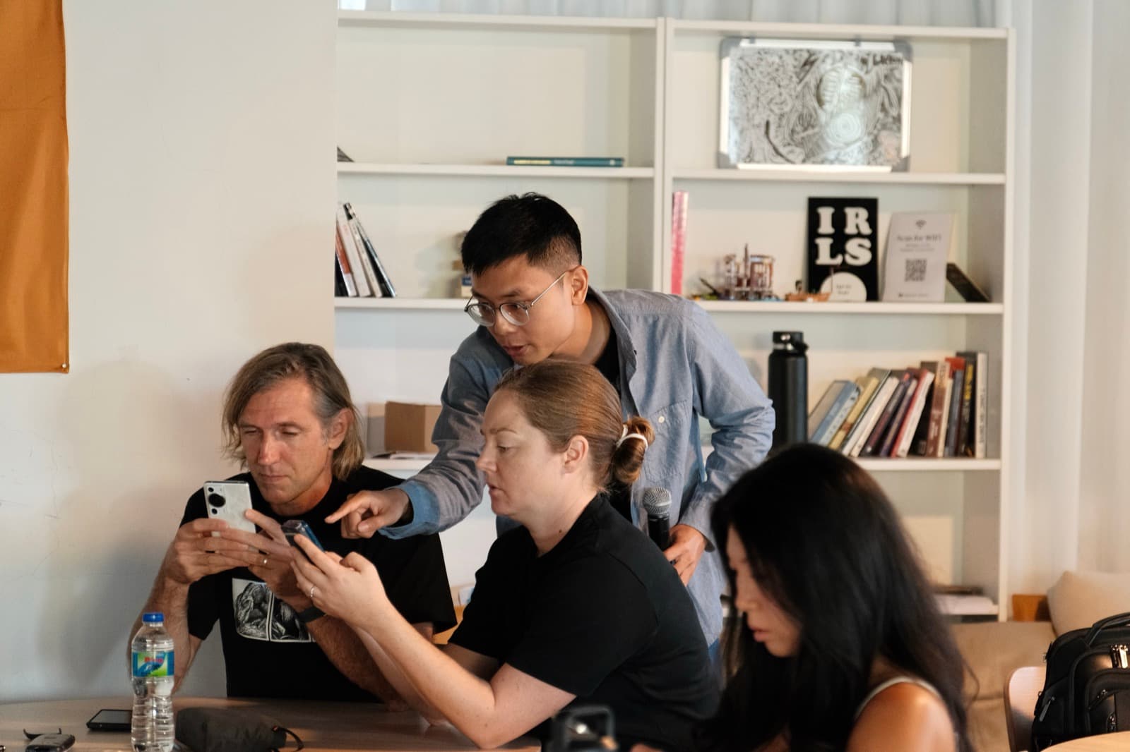 Tony guiding workshop participants through a calibration exercise at a table.